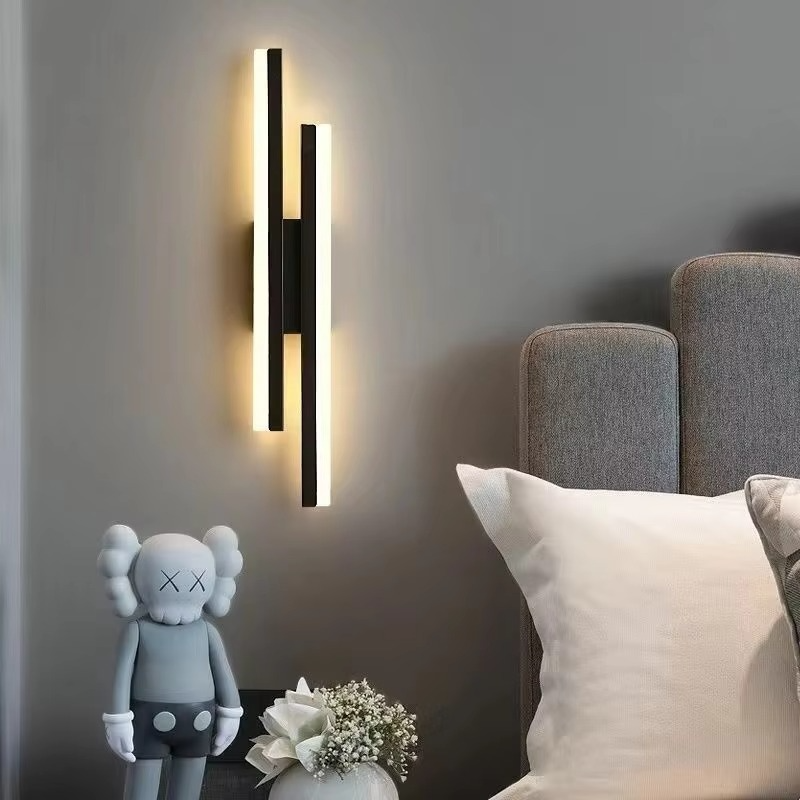 Black Lumina Linear LED wall sconce styled above a sofa with home decor